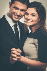Happy smiling couple in suit and dress