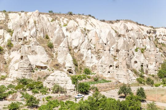 Wall of canyon in the National Park Goreme with man-made caves