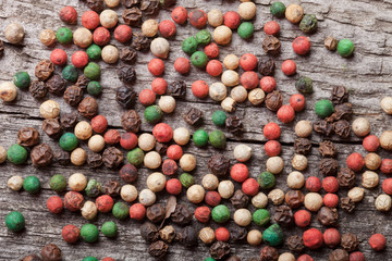 Colorful peppercorns on an old wooden table