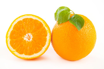 fresh cut oranges with leaves