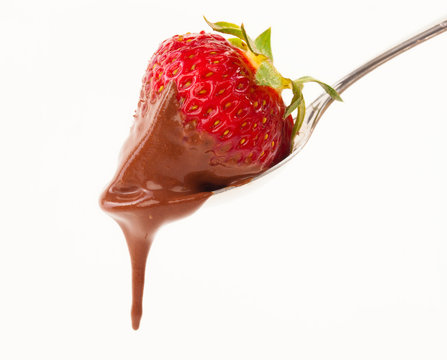 a heart shaped strawberry dipped in chocolate fondue