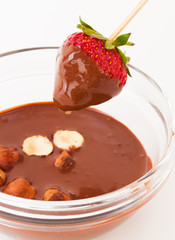 beautiful delicious strawberry with chocolate and nuts on stick