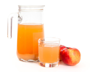 Jug of freshly squeezed apple juice, glass and two apples