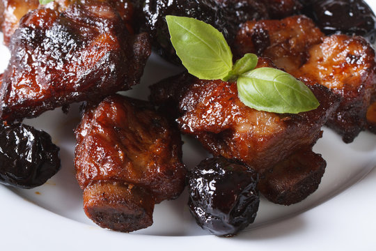 Pork ribs stewed with prunes and basil Horizontal close-up.