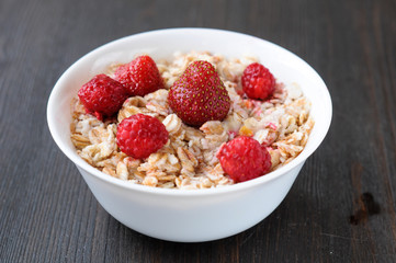 Cereal with strawberries and raspberries for breakfast