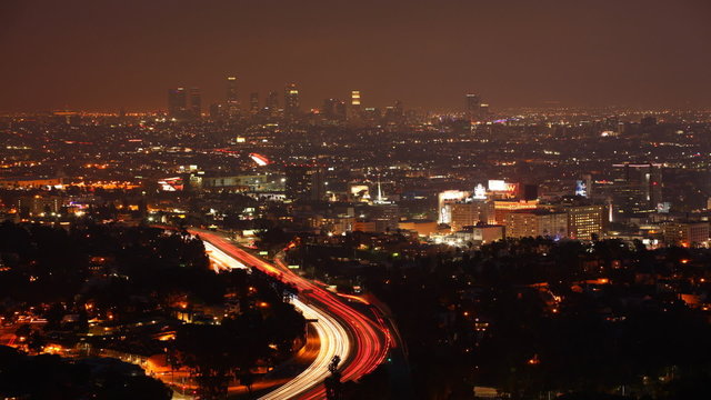 A timelapse view over Los Angeles at night with the lights of ex