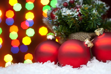Obraz na płótnie Canvas Christmas toys in the snow with a Christmas tree with garlands o