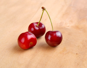 fresh red cherries on wooden background