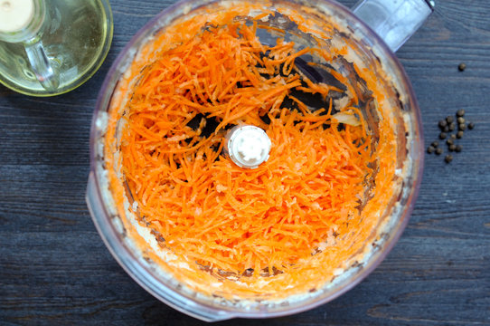 Chopped carrot in the food processor and olive oil