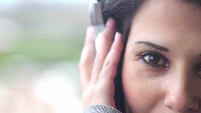 sensual woman listening to music while looking al the camera