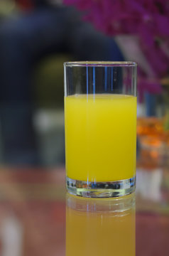 Orange juice glass on the table
