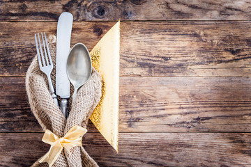 Old knife, spoon and fork decoratively presented.