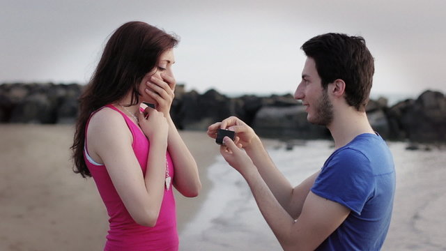 promise of marriage - man gives a ring to a woman