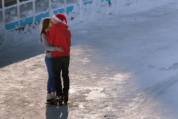 kissing teen couple at ice rink