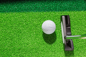Golf club and golf ball on green grass background. - obrazy, fototapety, plakaty