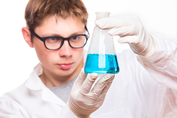 Chemist holding test tube in labolatory during reaction