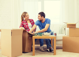 smiling couple unpacking kitchenware