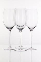 Four wine glasses on a glass desk