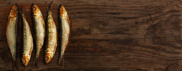 herring sprats smoked wooden oak background