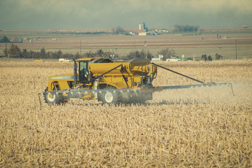 Fototapeta premium Farmer Spraying Fertilizer