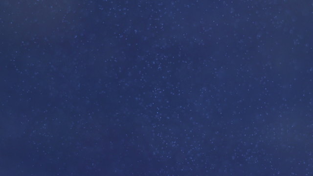 Dark blue underwater abyss shot with bubbles moving up and down