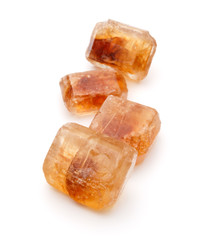 Brown caramelized lump cane sugar cube isolated on white backgro