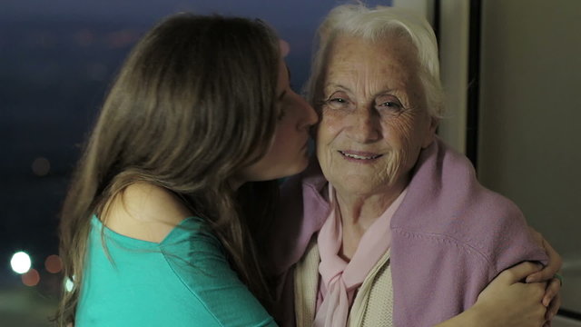 Granddaughter  kiss her grandmother