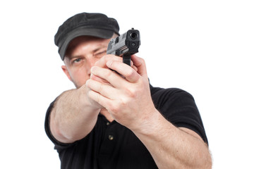 Man pointing gun, isolated on white. Focus on the gun