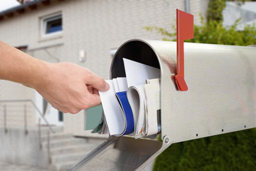 Man Taking Letter From Mailbox