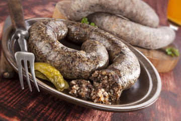 Blood sausage and rice sausage on wooden background.