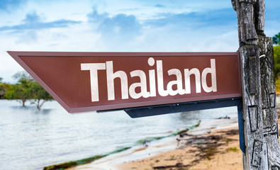 Thailand wooden sign with a lake background