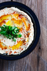 Fresh hummus with parsley and oil.