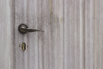Modern chrome handle on a wooden door