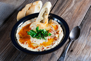 Fresh hummus with parsley and oil.