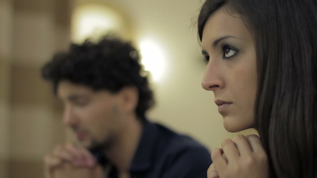 couple with many problems in prayer in a church