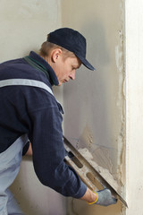Man gets manually gypsum plaster