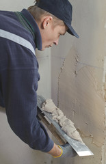 Man gets manually gypsum plaster