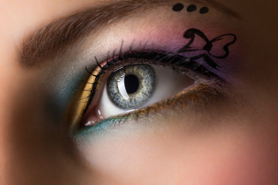 Close-up of woman eye with colorful make-up.