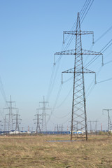 Spring landscape with electricity pylons.