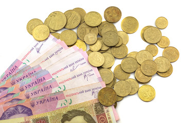 Ukrainian money and pennies on a white background