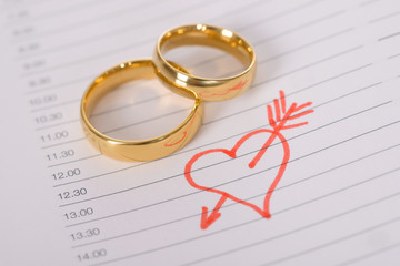 Close-up Of Wedding Rings On Paper