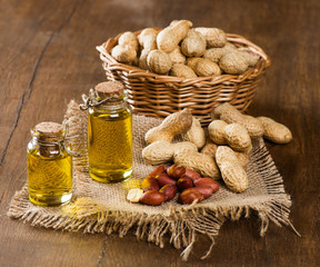 peanut oil and nuts on a wooden table