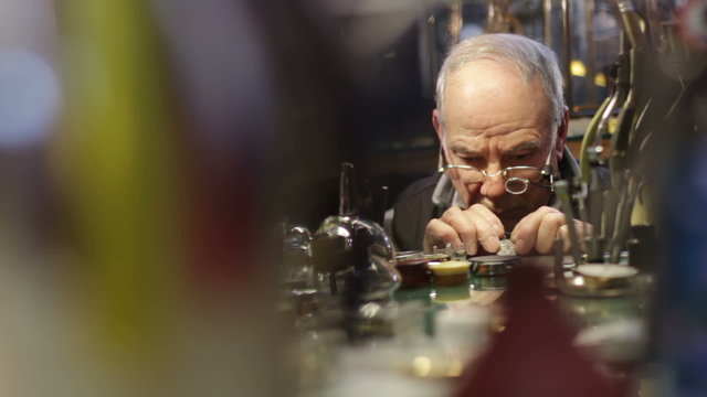 clockmaker checks the operation of a repair