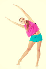 Young caucasian woman is doing exercises.