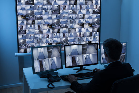 Man In Control Room Monitoring Cctv Footage