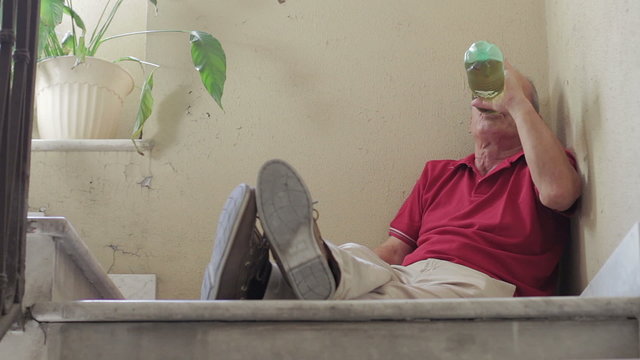 Drunk old man into the steep staircase