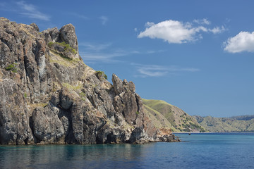 Fototapeta na wymiar Scenic rock at the sea coast - view from water