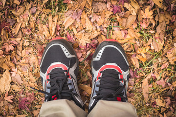 Feet Man stand on fall leaves Outdoor with Autumn season nature