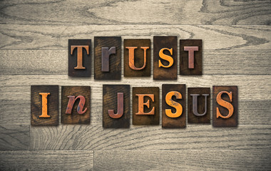Naklejka premium Trust in Jesus Wooden Letterpress Concept