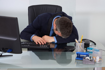 Tired Businessman At Desk